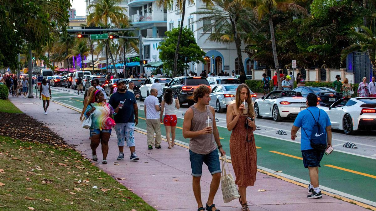 People walk Ocean Drive during the second day of Memorial Day Weekend in Miami Beach, Florida, on Saturday, May 28, 2022.