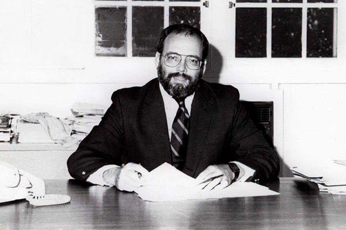 Ransom Everglades Social Studies Department Chair Mike Stokes, who also taught and coached at the Coconut Grove school, is seen at his desk in this file photo. “He encouraged us to experiment, to create and sharpen our own particular style, to think critically, to try new things,” wrote one of his students, Class of ’77’s Patty Shillington.