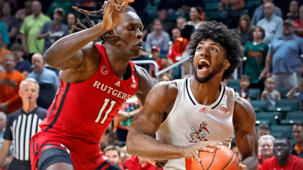 Miami Hurricanes forward Norchad Omier (15) battles Rutgers Scarlet Knights center Clifford Omoruyi (11) as he drives to the basket in the first half at the Watsco Center in Coral Gables on Wednesday, November 30, 2022.