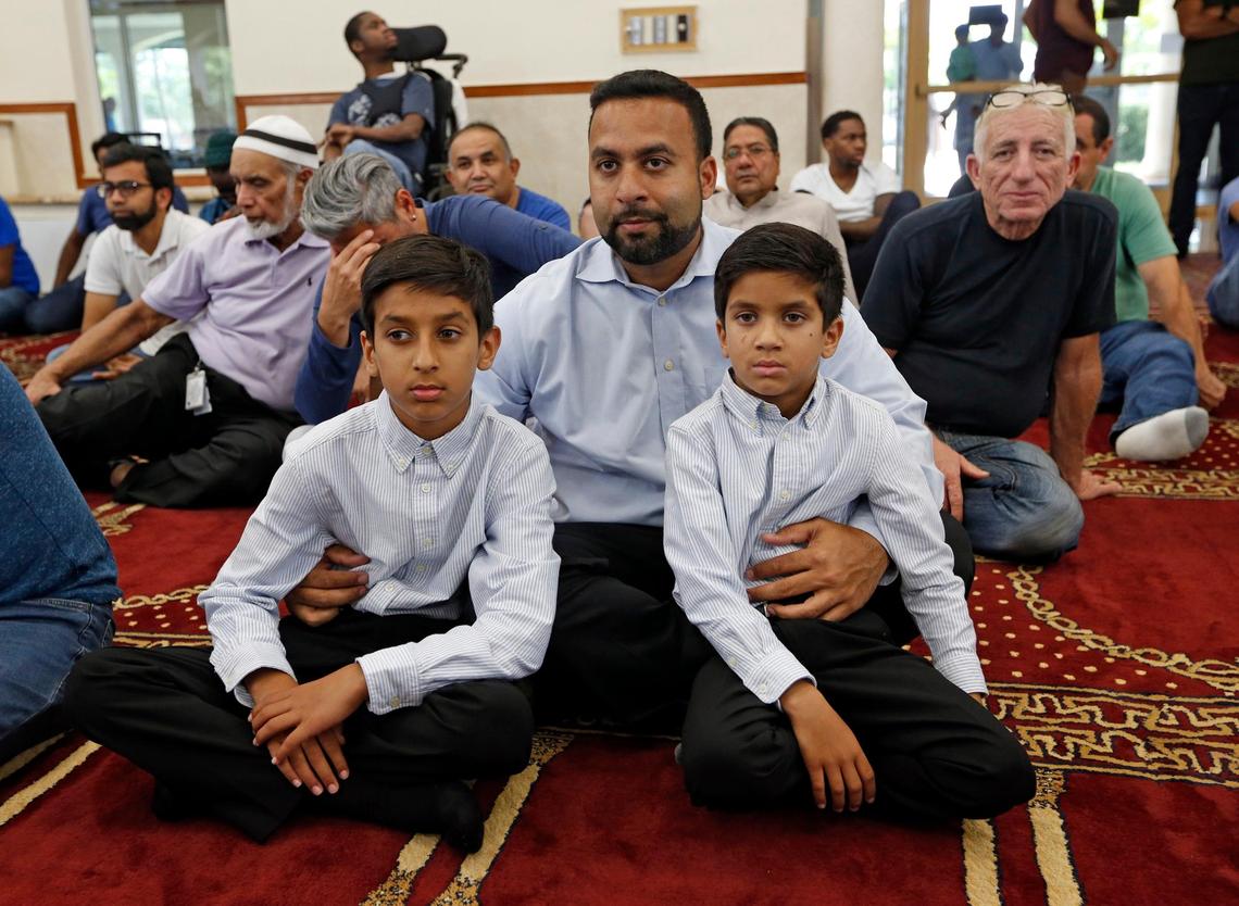 Azhar Dalal listens to the imam with his children Ameen Dalal, 11, left, and Hamza Dalal, 7, at the Islamic Center of Greater Miami in Miami Gardens on Friday, May 3, 2019.