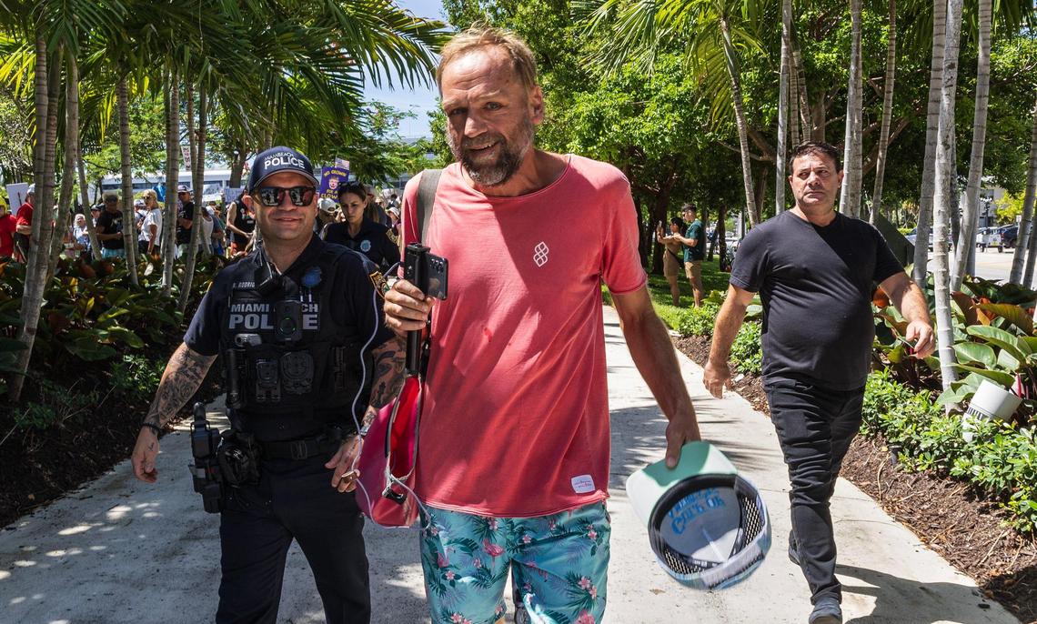 Counter protester Justin Nuland was escorted out of the Miami Beach No Kings protest at Pride Park by a Miami Beach police officer on Saturday, June 14, 2025.
