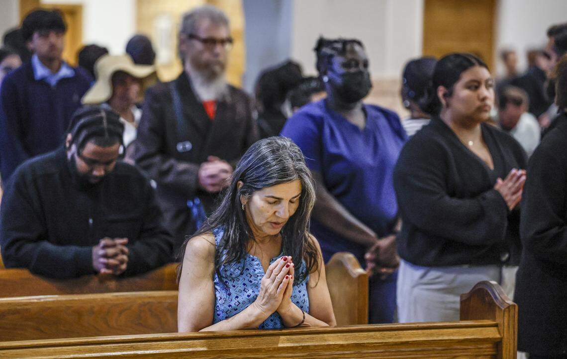 Parishioner Melfy Mesa prays as Archbishop Thomas Wenski presides over Good Friday of the Lord’s Passion at St. Mary Cathedral on Friday, April 3, 2026, in Miami.