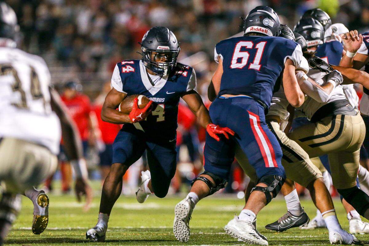 Columbus running back Sedrick Irvin (14) runs with the football and scores the game-wining touchdown during the fourth quarter of a high school football semifinal game against Ocoee at Tropical Park in Miami, Florida, Friday, December 2, 2022.