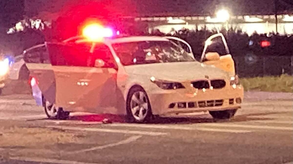 A white BMW is parked on the side of U.S. 1 at the intersection of Southwest 137th Avenue in Princeton Tuesday night, Feb. 23, 2021. The occupants of the car were involved in a shootout with people in another car, according to Miami-Dade County police.