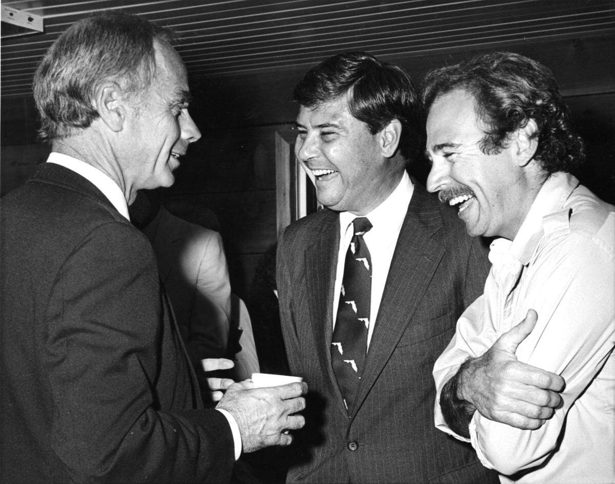 File photo features Miami public relations agent David Pearson (left), Sen. Bob Graham (center) and Jimmy Buffett (right) at a Save the Manatee event in Florida, circa 1981.