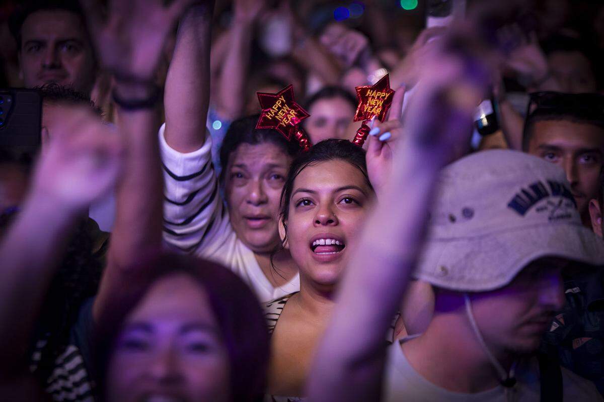 People sing along with performers during the New Year’s Eve Celebration.