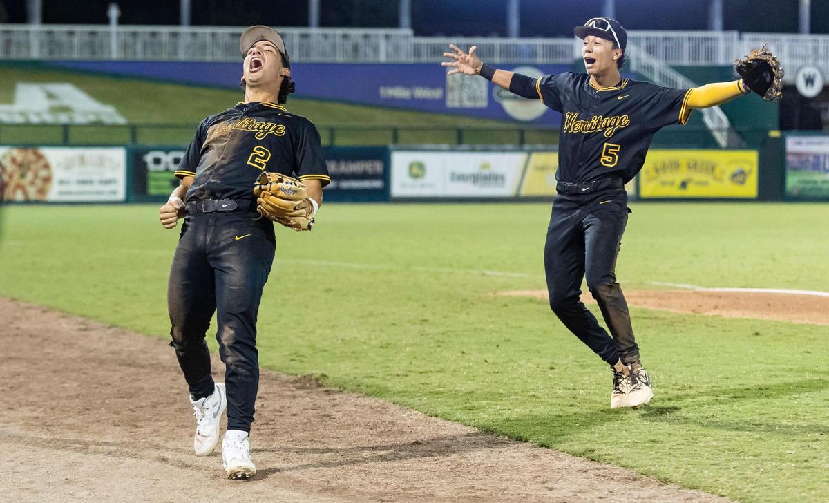 American Heritage Patriots RJ Machado (2) and Blayden Caballero (5) celebrate after their team defeated the Mulberry Panthers in their Class 4A state baseball championship game at Hammond Stadium on Tuesday, May 20, 2025, in Fort Myers, Fla.