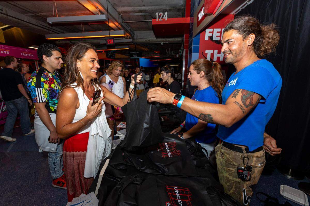 Tammy Darrows, 50, is handed a bag full of free books before the concert.