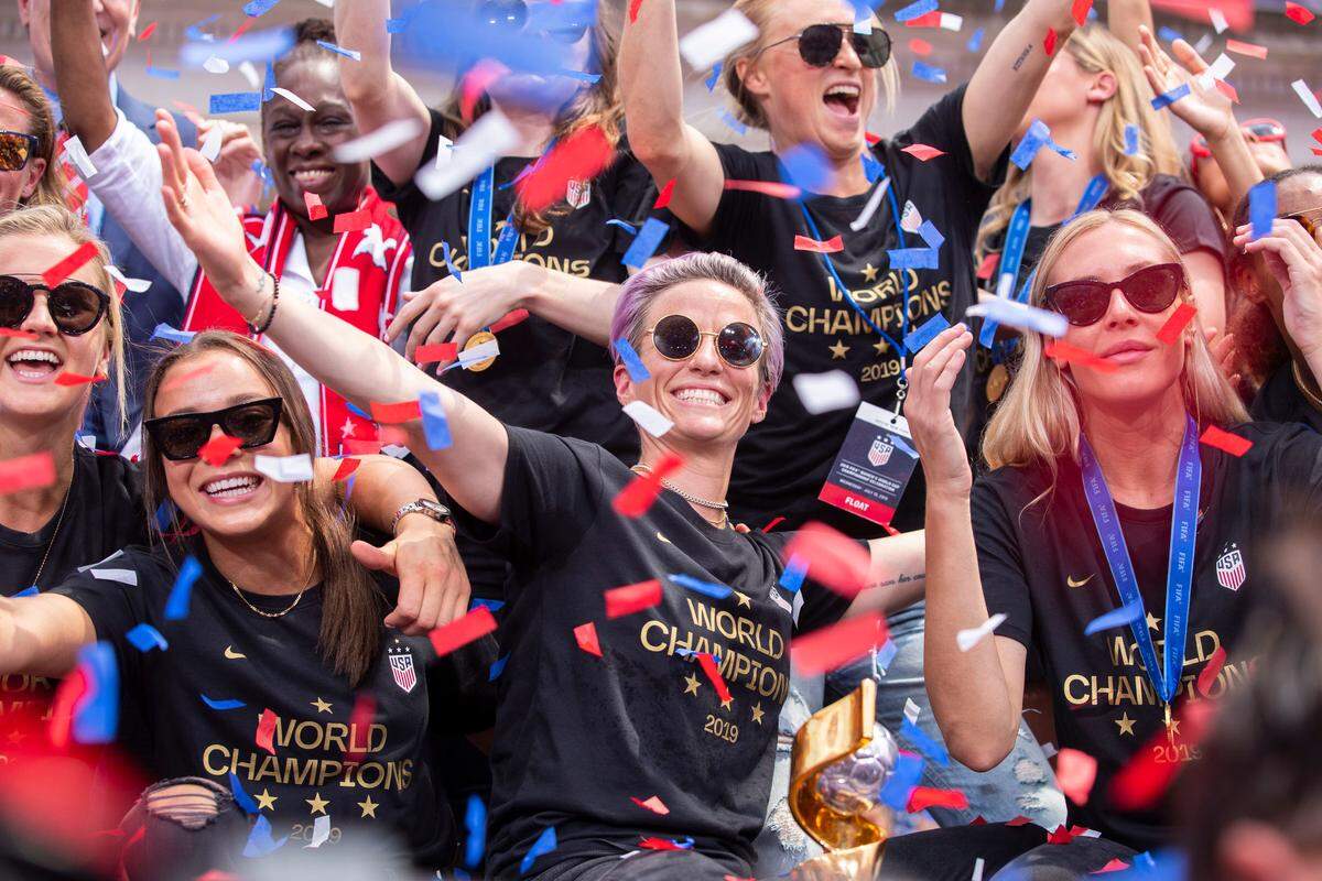 Megan Rapinoe, center, is joined by teammates as confetti falls outside of City Hall, after the team’s ticker-tape parade celebrating the U.S. women’s national soccer team’s World Cup victory, in New York on July 10 2019.
