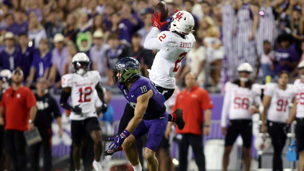 Oct 4, 2024; Fort Worth, Texas, USA; Houston Cougars defensive back A.J. Haulcy (2) intercepts a pass while defending TCU Horned Frogs wide receiver Jack Bech (18) in the second quarter at Amon G. Carter Stadium. Mandatory Credit: Tim Heitman-Imagn Images