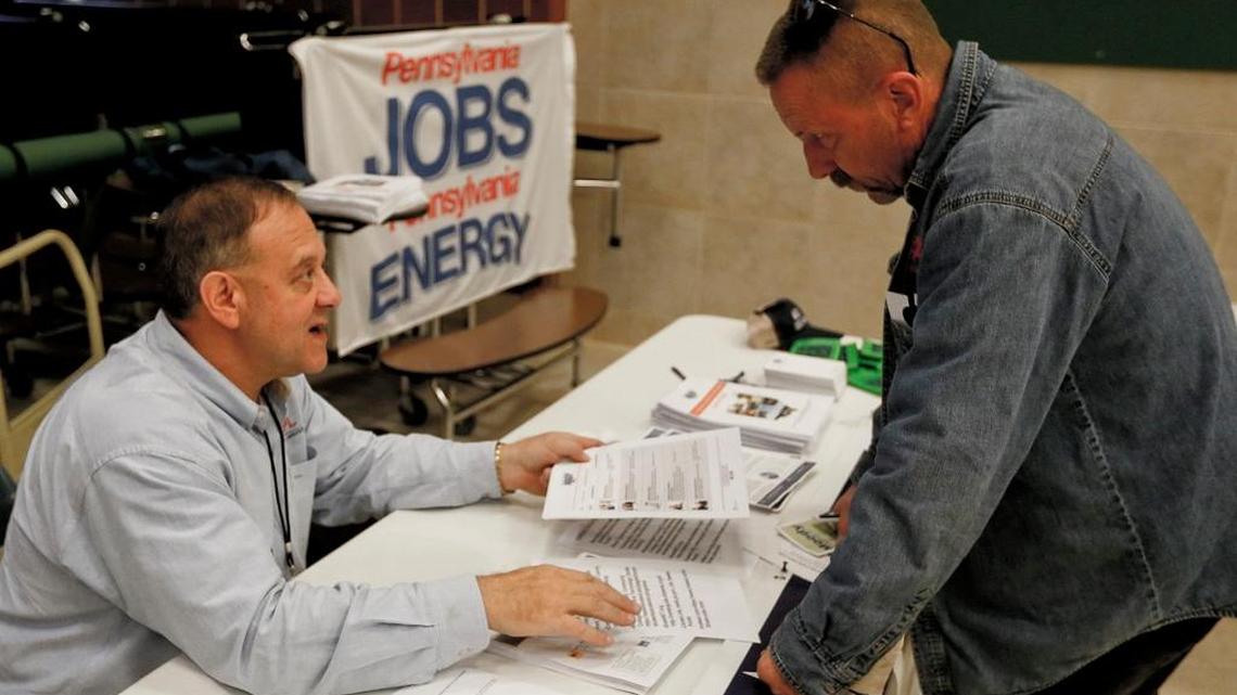 A recruiter in the shale gas industry, left, speaks with an attendee of a job fair in Cheswick, Pennsylvania last year. Wages went up for lots of workers last month, thanks to new withholding guidelines driven by the tax law. For a single person earning the average weekly wage, the new law adds about $28 a week to their pay after federal taxes. But it is important to note the data that will be released on Friday are pretax pay.