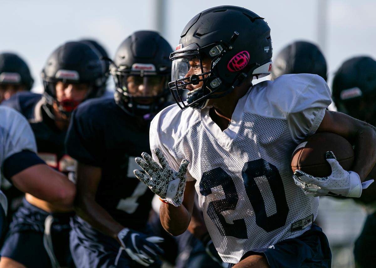 Christopher Columbus running back Denim Desrosiers runs drills during a preseason practice at his school in Miami’s Westchester neighborhood on Wednesday, August 4, 2021.