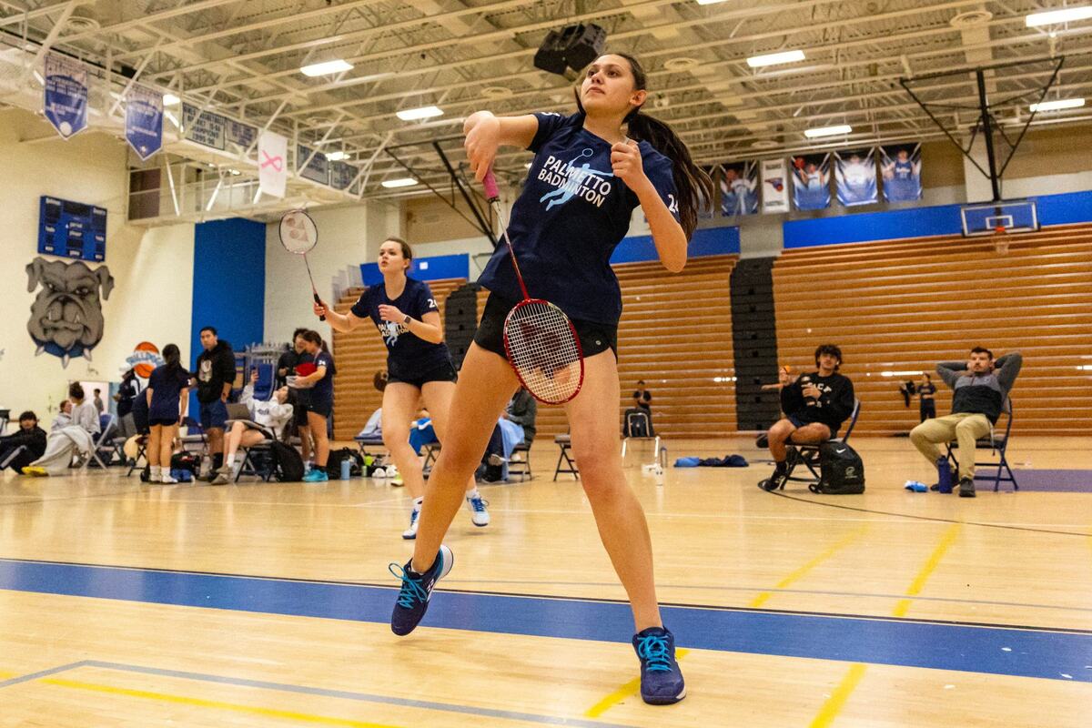 Isabella Reale, 17, right, returns a shot as Penelope Murray, 17, left looks on during the GMAC badminton final for women’s doubles at Braddock High School in Miami, Florida, on Thursday, April 18, 2024.