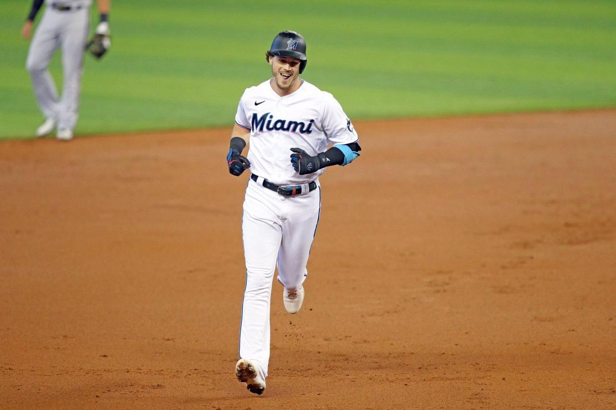 Miami Marlins third baseman Brian Anderson (15) rounds the bases after hitting on a fly ball homer to right field bringing in left fielder Corey Dickerson (23) and right fielder Adam Duvall (14) in the first inning during baseball game against Arizona Diamondbacks at loanDepot park in Miami on Tuesday, May 4, 2021.
