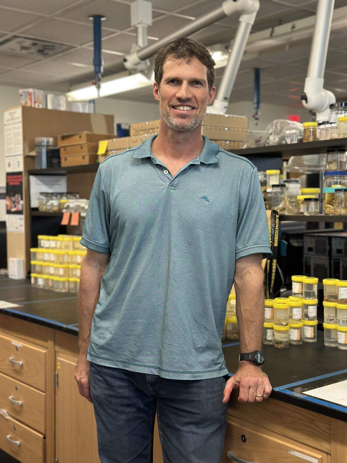 Nathan Dorn, aquatic ecologist and researcher at Florida International University, poses in his lab where he and his team study the invasive asian swamp eel.