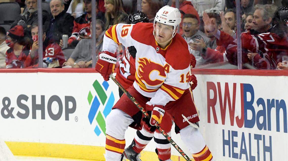 Calgary Flames left wing Matthew Tkachuk (19) looks to pass the puck during the second period of an NHL hockey game against the New Jersey Devils Tuesday, Oct. 26, 2021, in Newark, N.J.