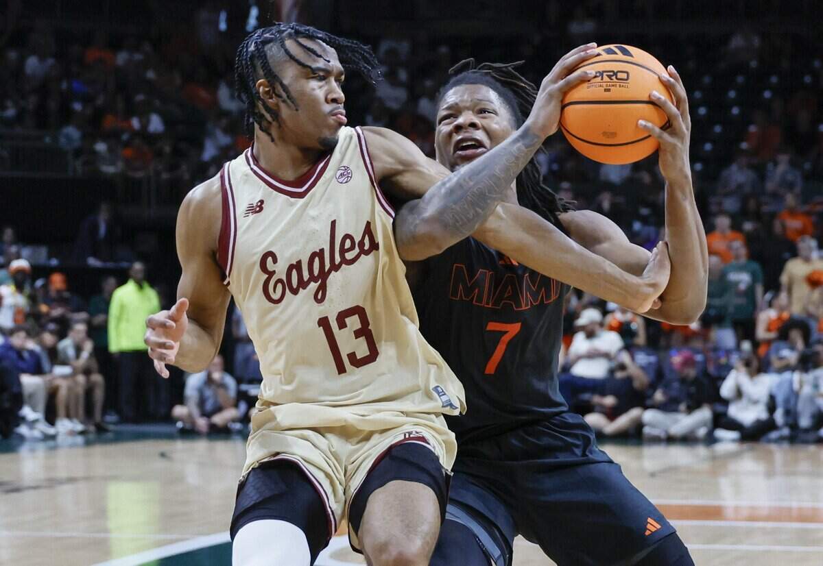 Miami Hurricanes forward Shelton Henderson (7) battles to Boston College Eagles guard Donald Hand Jr. (13) in the first half at the University of Miami's Watsco Center in Coral Gables, Florida, on Saturday, February 28, 2026.