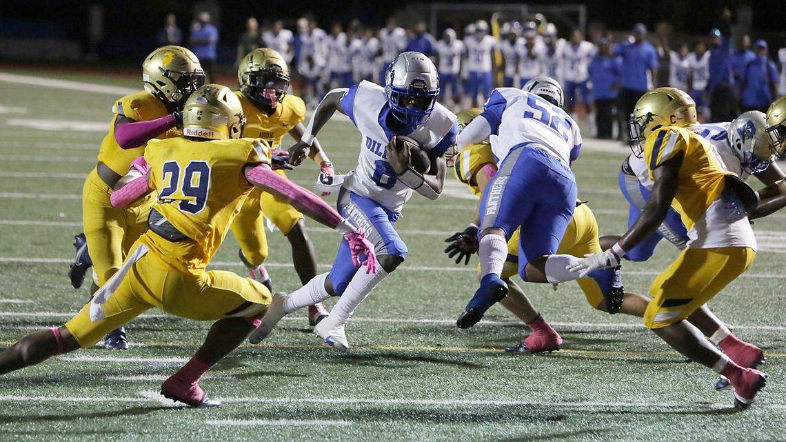 Dillard Panthers Christopher Johnson (6) carries the ball as St. Thomas Aquinas Raiders defenders move in to stop him during football game Friday, October 22, 2021 at St. Thomas Aquinas HS in Fort Lauderdale