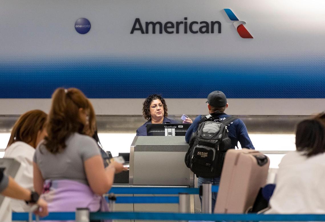 Travelers visit the American Airlines check-in area at the Miami International Airport on Monday, May 1, 2023, in Miami, Fla. Following four years of negotiations, the Allied Pilots Association agreed upon a strike authorization on behalf of American Airlines pilots.