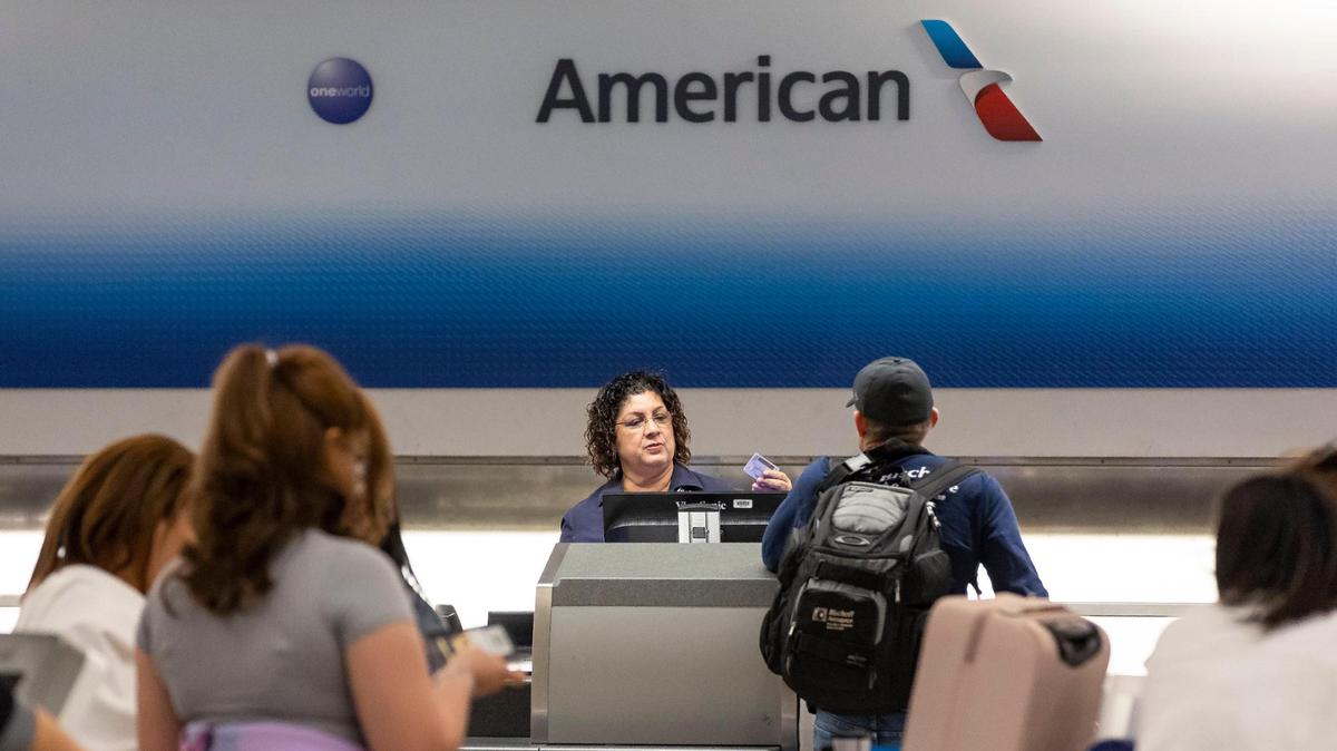 Travelers visit the American Airlines check-in area at the Miami International Airport on Monday, May 1, 2023.