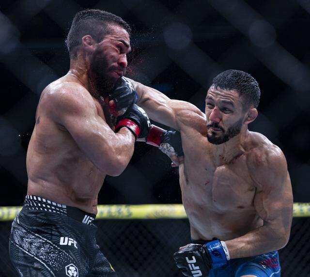Patricio Pitbull of Brazil and Aaron Pico of the United States fight in their featherweight bout at UFC 327 at the Kaseya Center on Saturday, April 11, 2026, in downtown Miami, Fla.