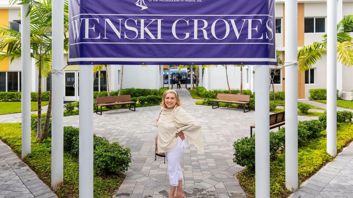 Zully Mar Vidal stands in the courtyard of Wenski Groves, an affordable housing complex created through Catholic Charities of the Archdiocese of Miami. Vidal moved last year after facing financial hardship.