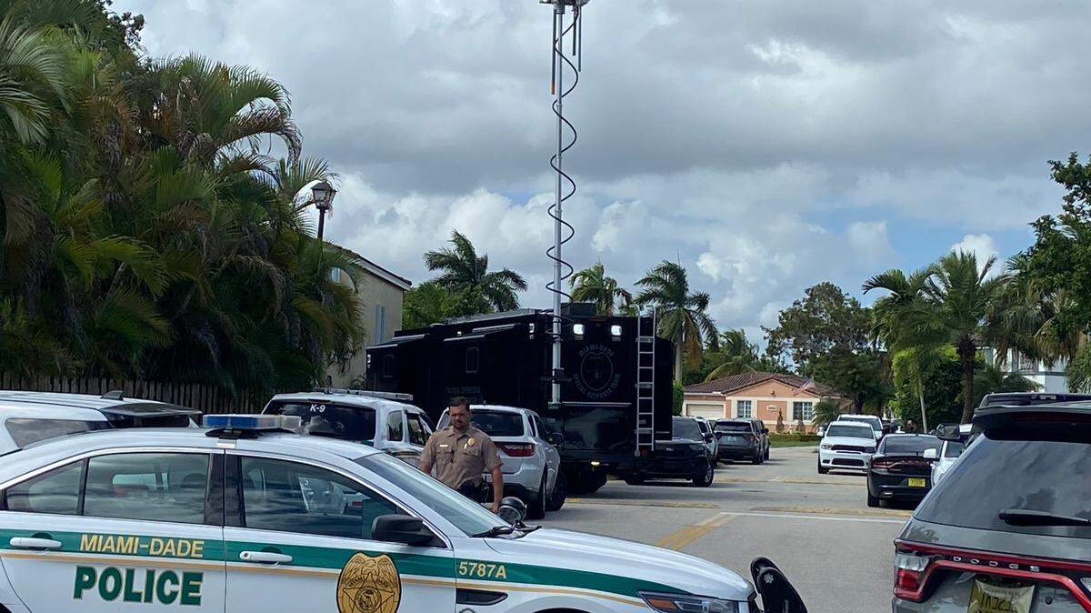 Patrol cars and Miami-Dade County Police’s Special Response Team truck are parked in front of a home on Southwest 173rd Street Friday, Oct. 27, 2023.