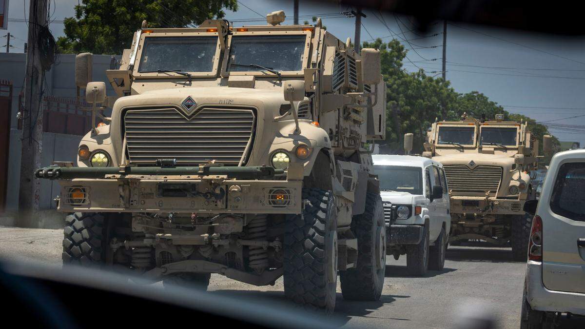 Armored vehicles used by Kenyan police rumble through the streets of Port-au-Prince, Haiti. The vehicles are part of the United States’ more than $300 million in contributions to the U.N.-backed Multinational Security Support mission.