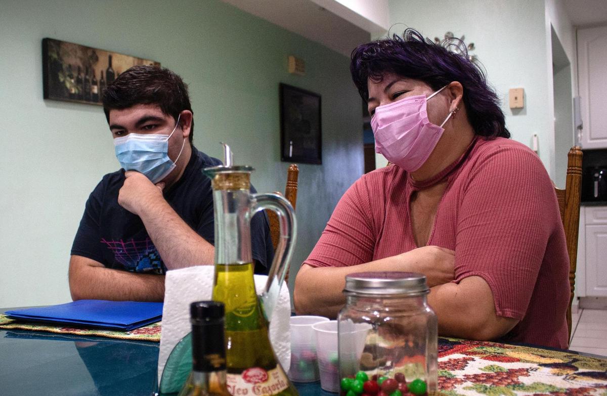 Andres Lorenzo, 22, and his mother, Sady Lorenzo, 50, in their home in Hialeah. Andres is autistic and struggles with breaks in his routine. A generator would help keep his circumstances on track when there is a power outage.