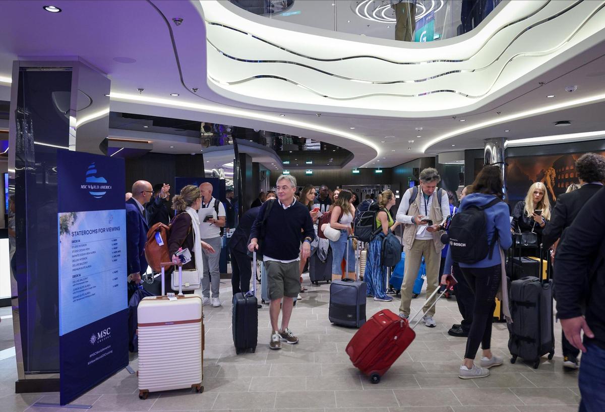 Passengers check in with their luggage on the MSC World America.