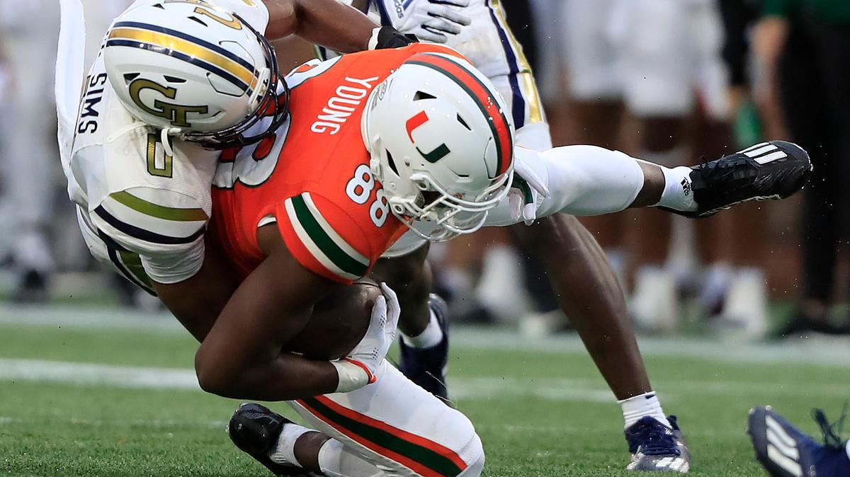 ATLANTA, GA - NOVEMBER 12: Georgia Tech Yellow Jackets defensive back Myles Sims (0) tackles Miami Hurricanes wide receiver Colbie Young (88) during the Saturday afternoon college football game between the Miami Hurricanes and the Georgia Tech Yellow Jackets on November 12, 2022 at Bobby Dodd Stadium in Atlanta, GA. (Photo by David J. Griffin/Icon Sportswire) (Icon Sportswire via AP Images)