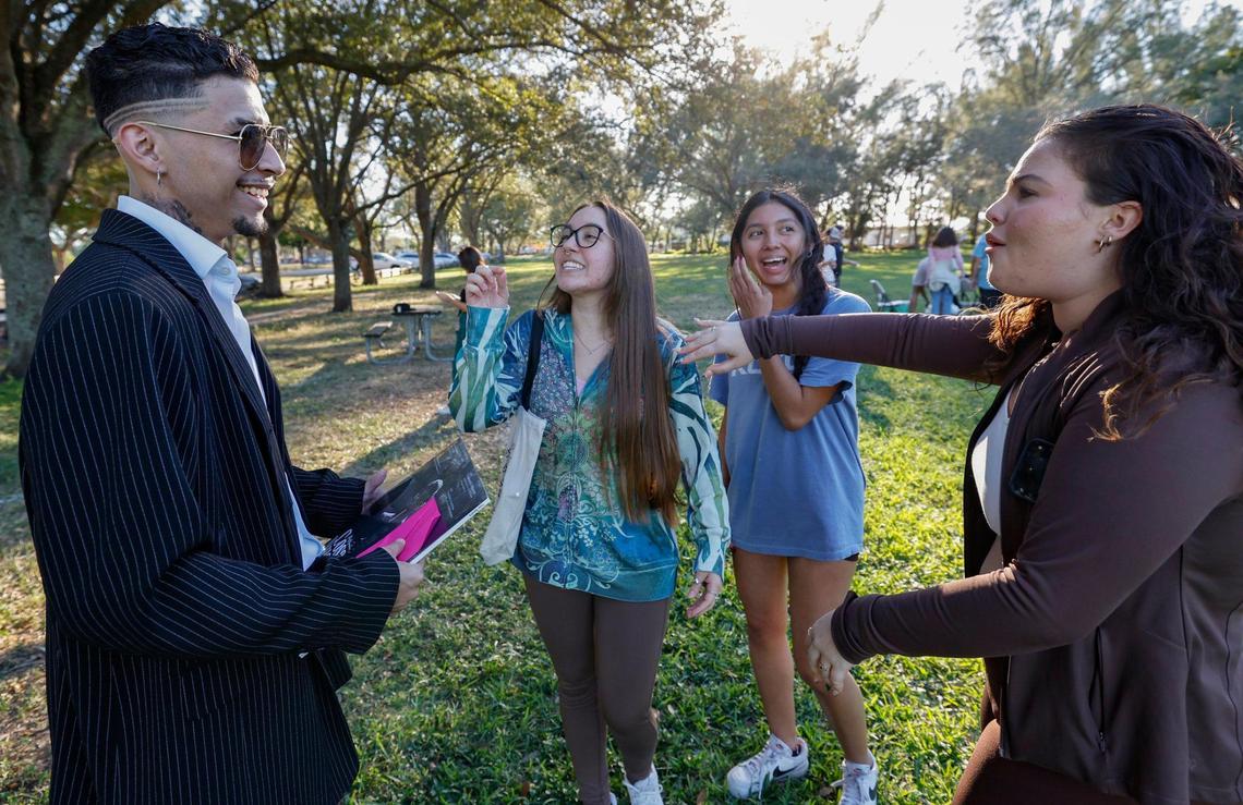 Alejandro Restrepo, 25, of Miami is greeted by Alessandra Vannucci, 20, Sophia Velasquez 20, and Catherine Mas, 21, seen left to right. Restrepo won the Rauw Alejandro look-alike contest at Tropical Park in Miami, Florida, on Friday, November 22, 2024.