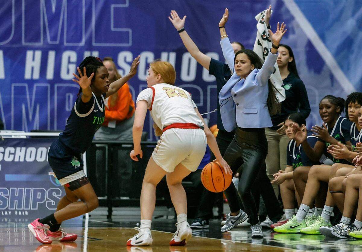 SLAM Miami Titans coach Krystal Cabrera reacts from the bench as Titan’s Kakayla Turner (4) defends against Cardinal Mooney’s Riley Martin (23) in the first half during girls 3A basketball semifinal game of the Florida High School State Championships.