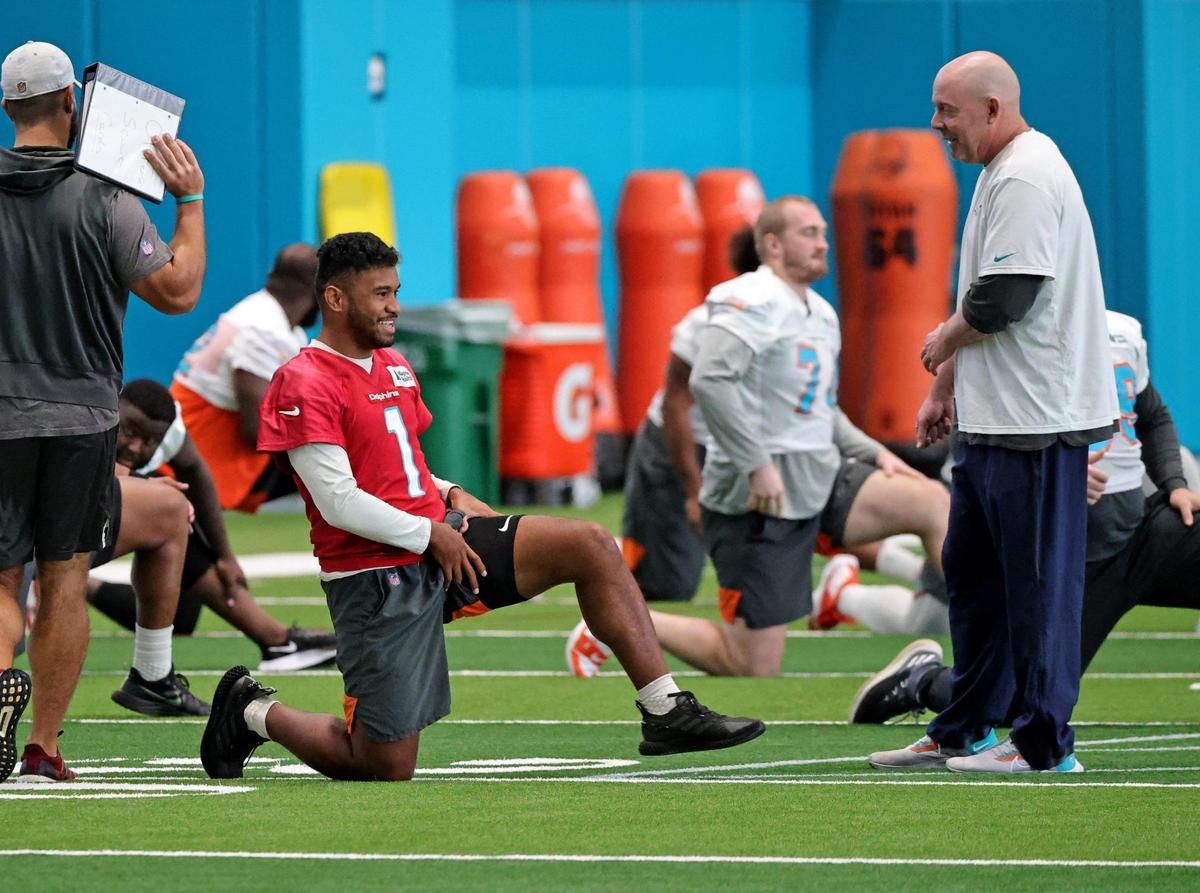Miami Dolphins co-offensive coordinator George Godsey talks with Dolphins quarterback Tua Tagovailoa (1) during practice at Baptist Health Training Complex in Hard Rock Stadium on Wednesday, October 20, 2021 in Miami Gardens, Florida, in preparation for their game against the Atlanta Falcons at Hard Rock Stadium on Sunday, October 24.
