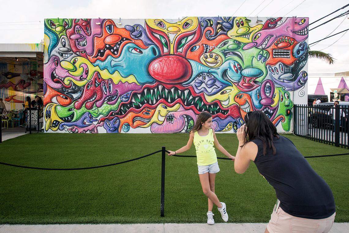  A visitor snaps a photo at the Kenny Scharf mural at the Wynwood Walls entrance. Kids under 17 will still get into Wynwood Walls free of charge.