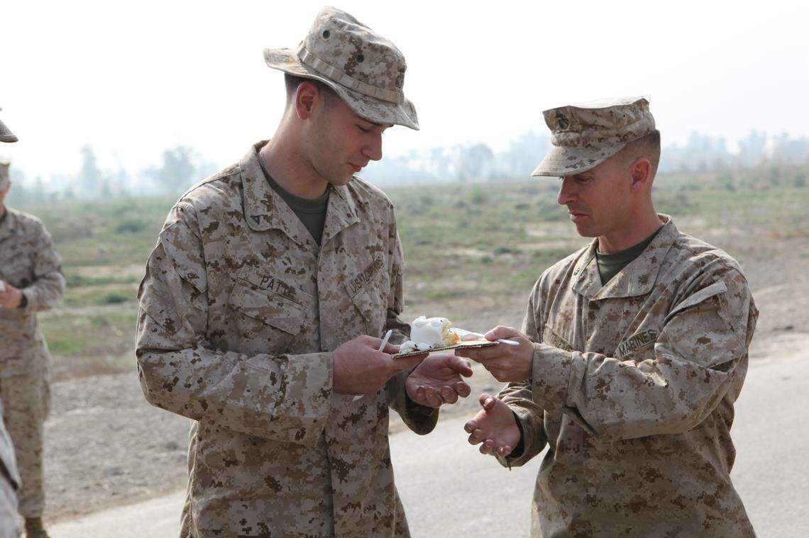 Major Mark Thieme, right, passes a piece of cake to Lance Cpl. Joseph Patti during a Marine Corps birthday ceremony on the flight line at Pano Aqil Cantonment, Pakistan, Nov. 10, 2010. With the Pakistan military, 26th MEU Marines flew CH-53E Super Stallion Helicopters to isolated flood-affected locations and transported more than 3.9 million pounds of World Food Programme flood relief supplies to 150 different locations in southern Pakistan.
