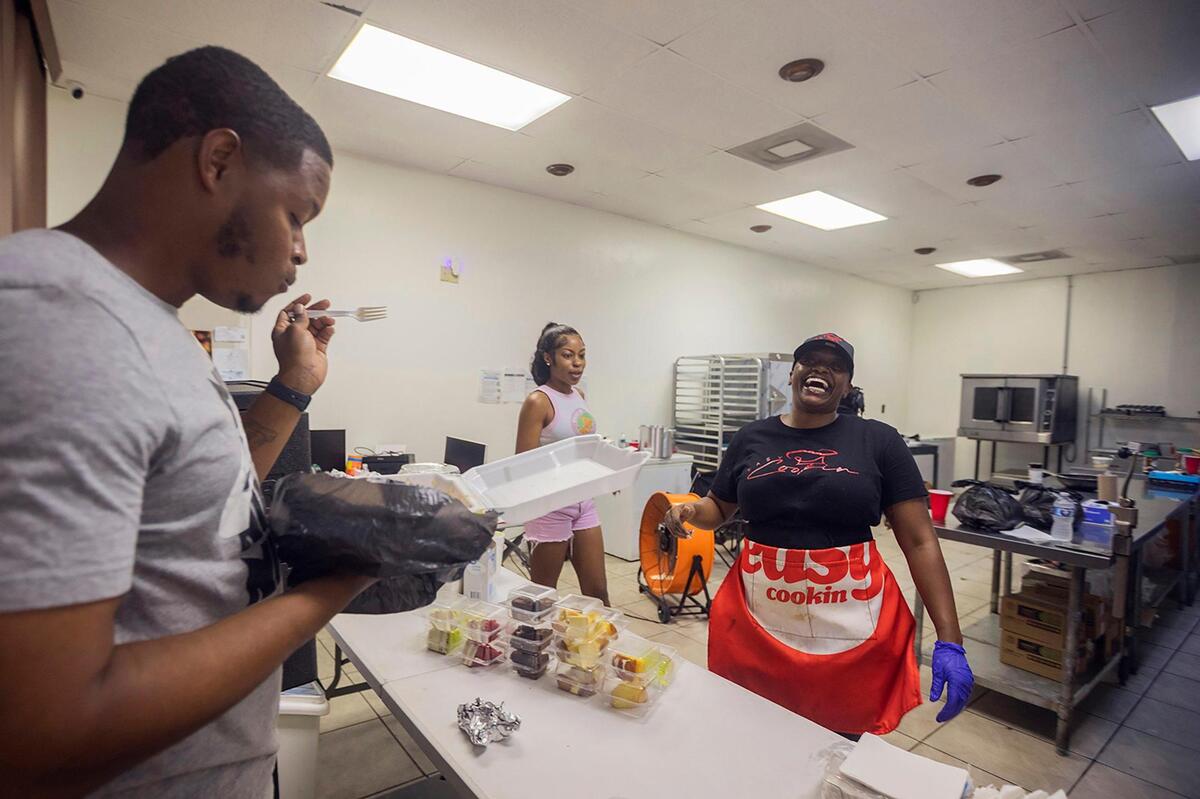 James Anderson, left, samples Jamaican chicken pasta during a food event hosted by Chef Syerra Donaldson on Saturday, May 24, 2025.