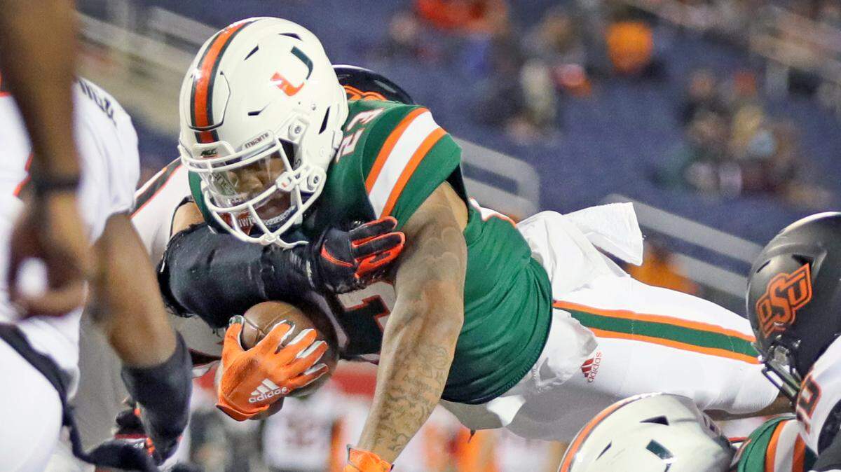 Miami Hurricanes running back Cam’Ron Harris (23) dives short of the goal line against Oklahoma State Cowboys during the 2020 Cheez-It Bowl at Camping World Stadium in Orlando on Tuesday, December 29, 2020.