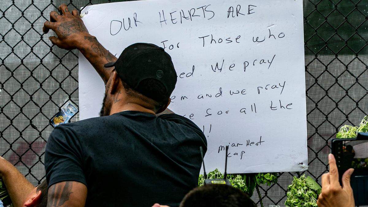 Miami Heat’s Udonis Haslem wrote a message of support as he visits the memorial wall for the missing people in the collapsed Champlain Towers South Condo, located at 8777 Collins Avenue in Surfside, on Wednesday, June 30, 2021.