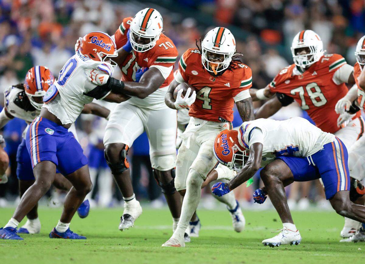 Miami Hurricanes running back Mark Fletcher Jr. (4) on a carry against the Florida Gators in the second half of their NCAA football game at Hard Rock Stadium.