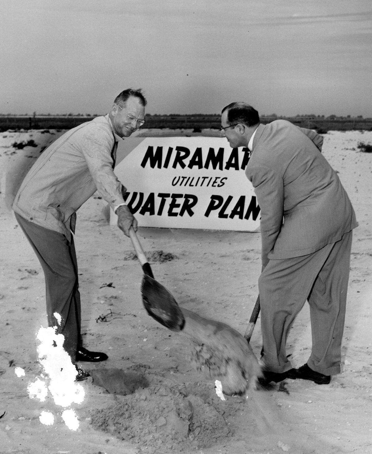 In 1954, Hallandale Mayor Foster Ingalls, left, wields a shovel in ground-breaking ceremonies that mark the start of Miramar’s water plant, designed to serve the 4,000 home community going up just west of Hallandale. Ingalls gets a hand from Robert W. Gordon, right, of Hollywood, president of the Miramar Corp. which is building the development.