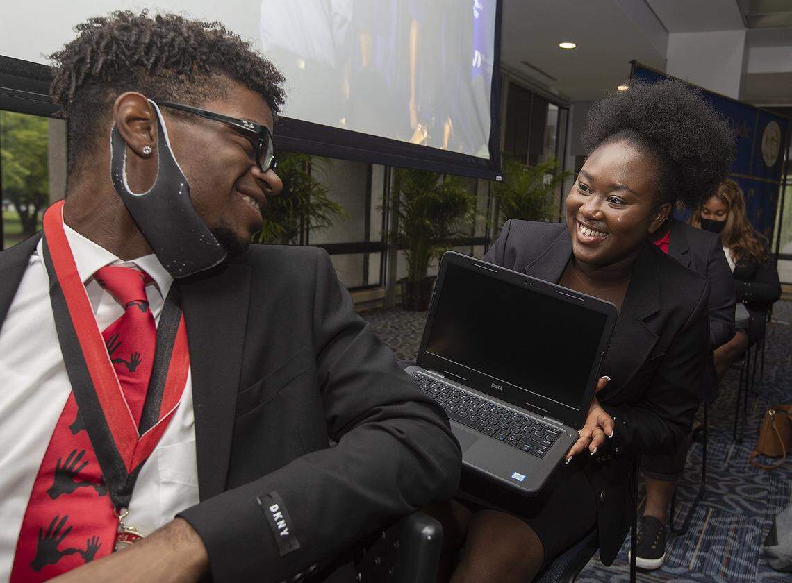 Jovnia Richard, 18 years old, from Homestead Senior High and who wants to study psychology, shows her new laptop to Nathaniel Forbes, 18 years old, from Robert Morgan Educational Center, who wants to study pre-med. They were part of the 5000 Role Models Excellence Project inaugural class at MDC North Campus Conference Center on Tuesday June 6, 2021.