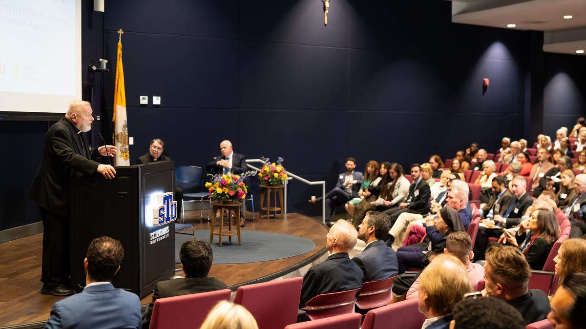 Miami Archbishop Thomas Wenski speaks to a crowd at St. Thomas University for an event celebrating the 60th anniversary of Nostra Aetate, a historic declaration that opened the door to interfaith relationships between Catholics and non-Christian religions.