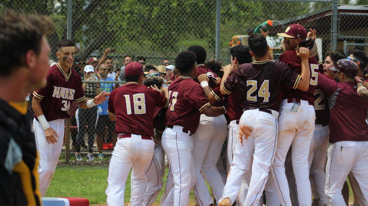 The Miami Springs baseball team mobs freshman Jason Torres after he hit a walkoff home run against Plantation American Heritage in the Region 4-6A semifinal on Saturday, May 18, 2018.