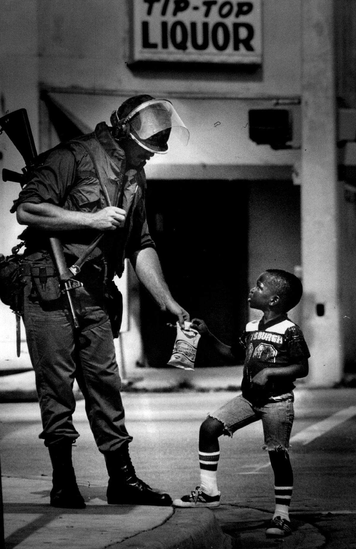 In 1980, on Grand Avenue and Douglas Road in Coconut Grove, National Guardsman Milton O’Dell meets 5-year-old Joe Rickenbacker Jr.