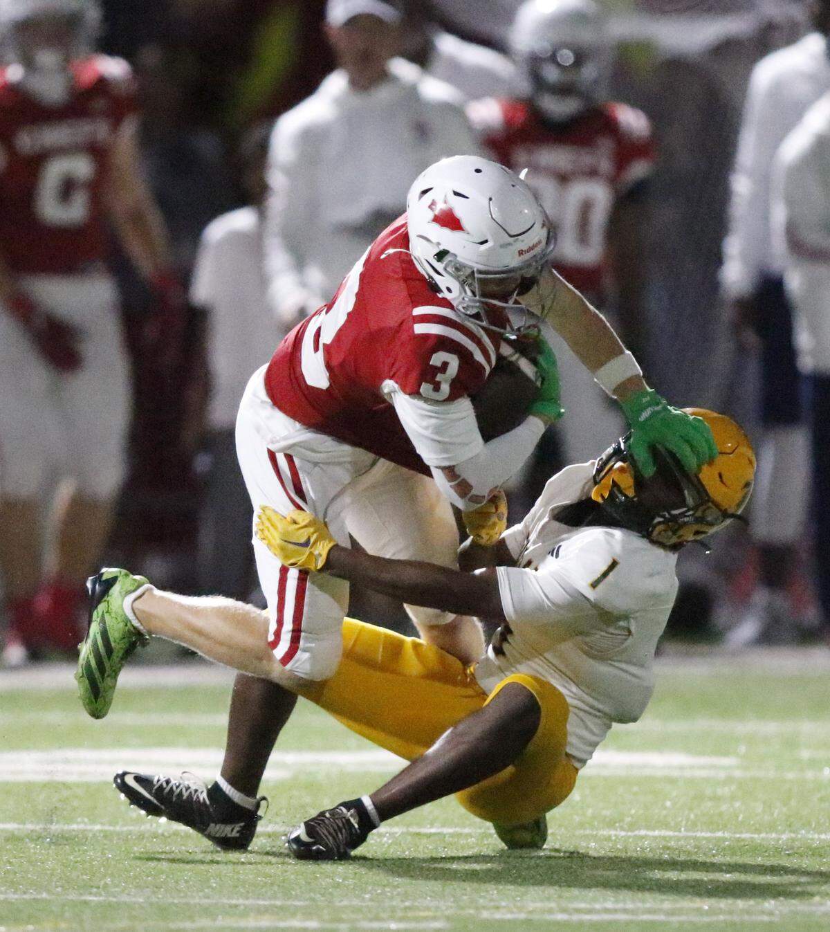 Killian Cougars Anton Smith (1) tackles Cardinal Gibbons Chiefs wide receiver Merrick Todich (3) during Region 4-2A semifinal football game on Friday, November 21, 2025 at Cardinal Gibbons HS in Fort Lauderdale. Andrew Uloza / for Miami Herald