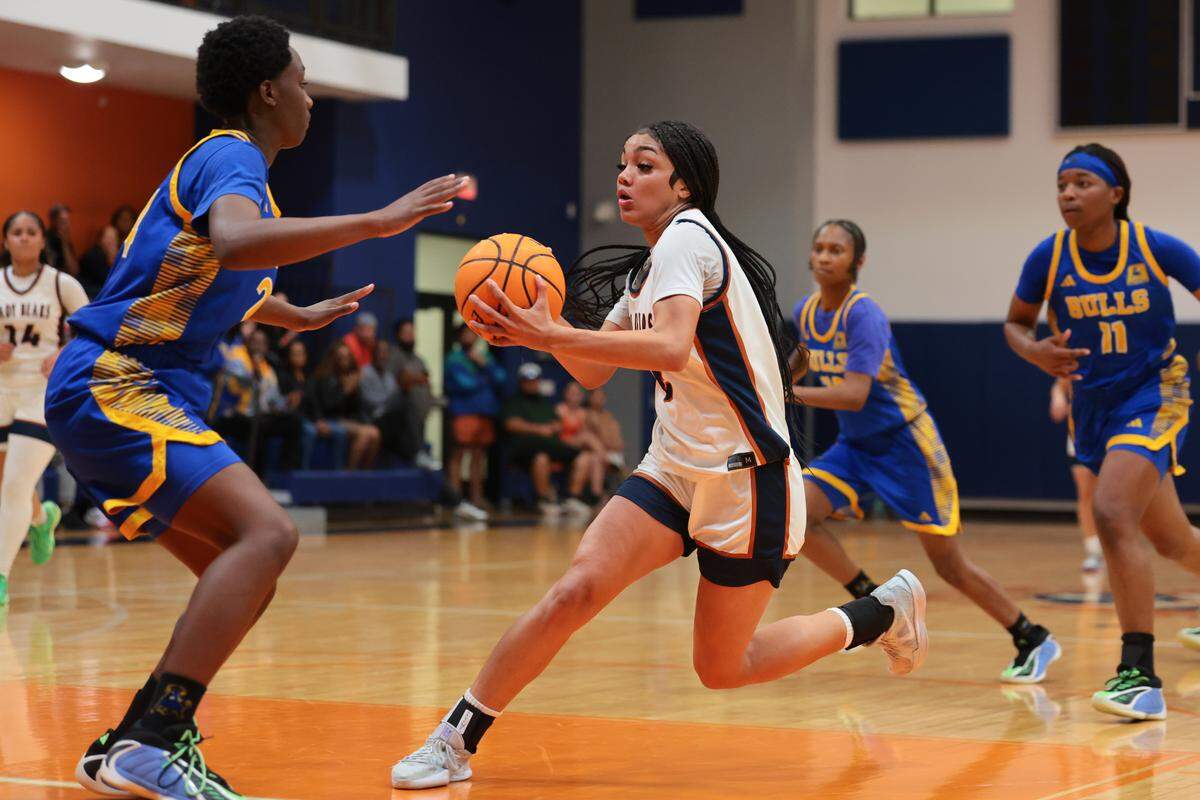 Mater Lakes Academy Bears Vanessa Vancott (2) drives to the basket against Northwestern Bulls Tayana Dixon (24) in the fourth quarter during a girls' basketball Region 4-4A semifinal playoff game at Mater Lakes Academy on Friday, February, 20, 2026, in Hialeah, Fla.