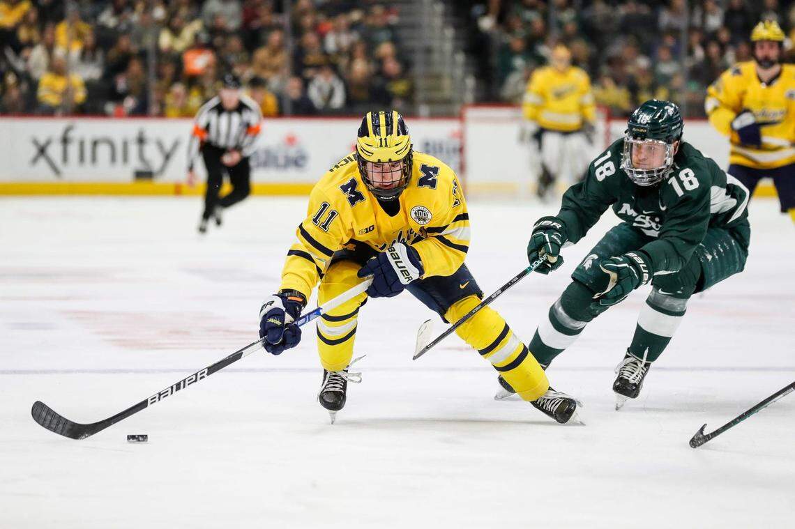 Michigan forward Mackie Samoskevich is defended by Michigan State forward Miroslav Mucha during the first period on Saturday, Feb. 11, 2023, at Little Caesars Arena.