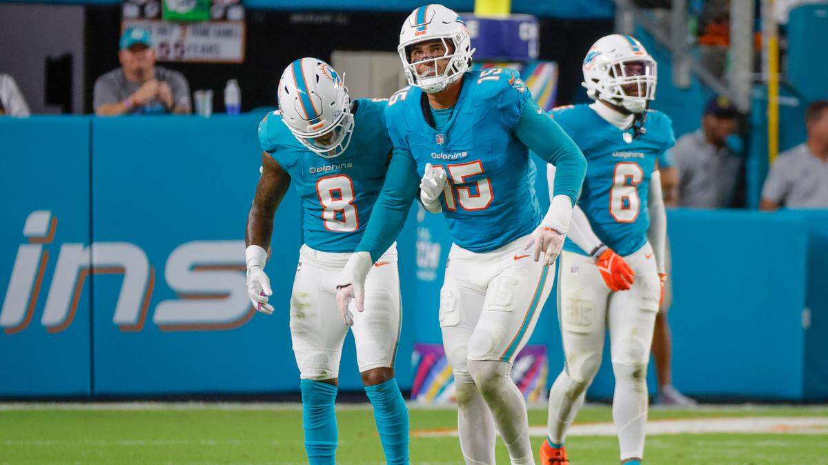 Miami Dolphins linebacker Jaelan Phillips (15) is assisted off the field by safety Jevon Holland (8) after getting injured in the first half against the Tennessee Titans of their NFL game at Hard Rock Stadium on Monday, September 30, 2024, in Miami Gardens, Fla.