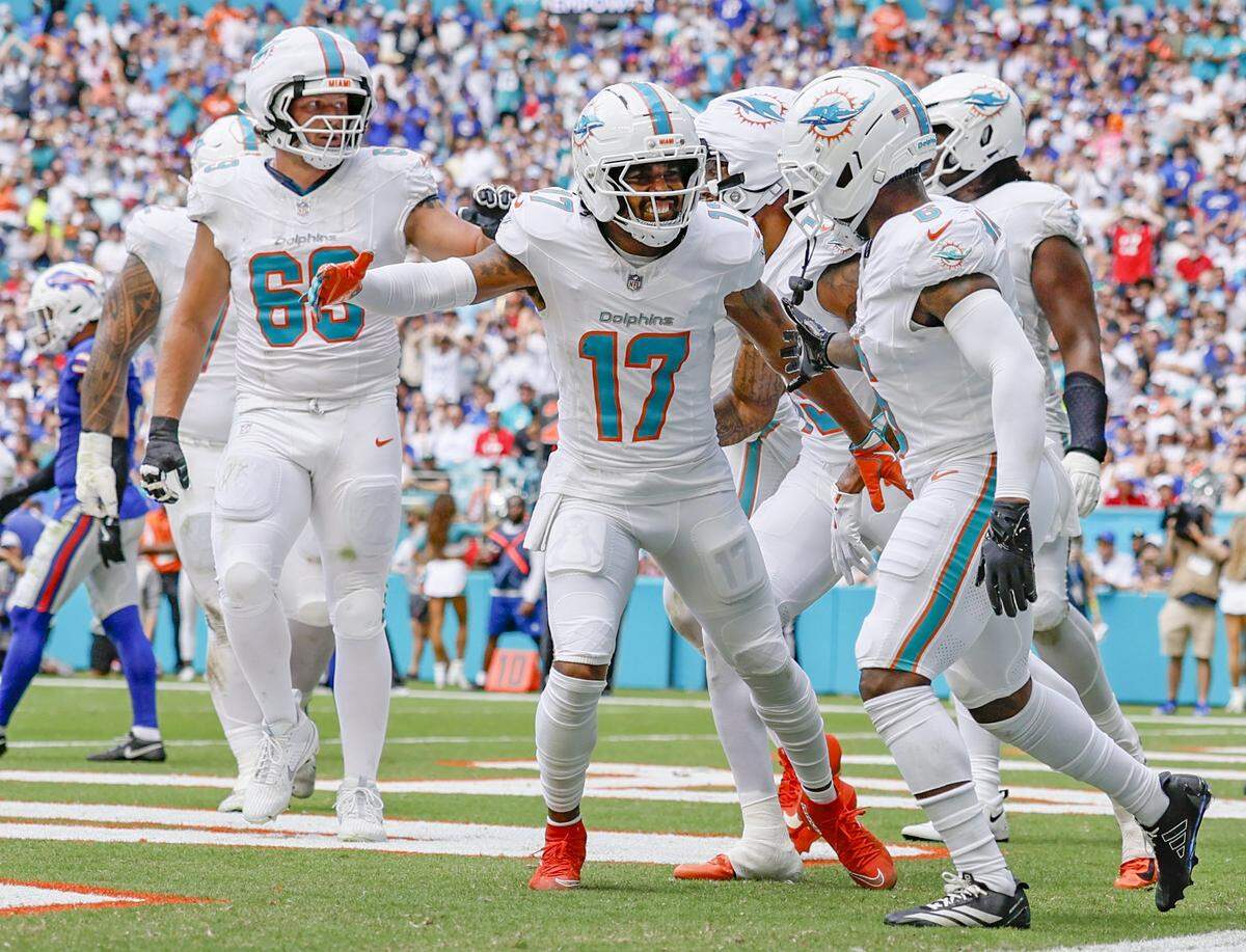 Miami Dolphins wide receiver Malik Washington (6) celebrates with fellow receiver Jaylen Waddle (17) in the end zone after Washington scores against Buffalo Bills in NFL football game at Hard Rock Stadium in Miami Gardens, Florida on Sunday, November 9, 2025.